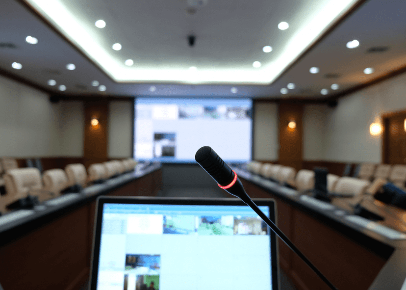 Close-Up Of Microphone And Laptop In Conference Room