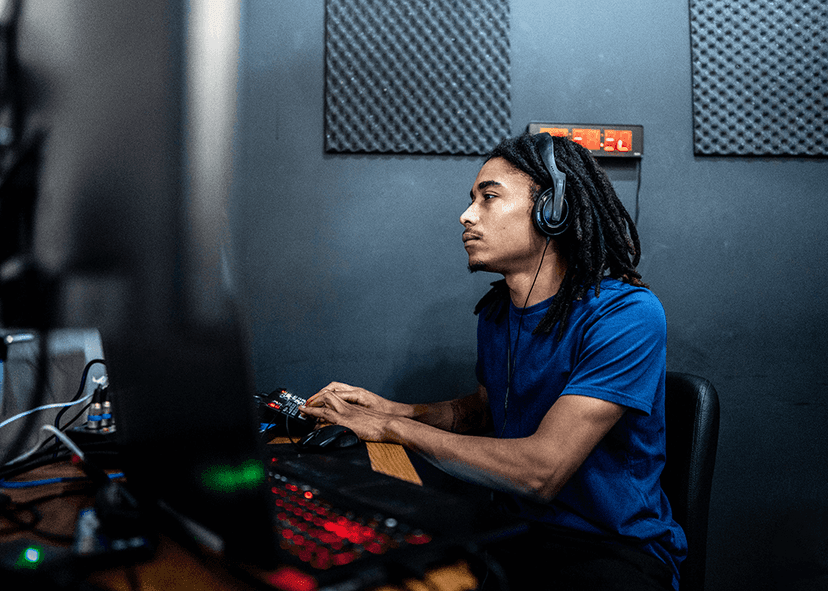 Audio engineer wearing headphones at a desk